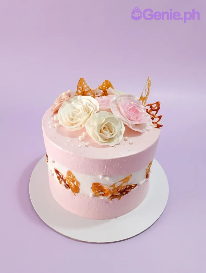 A pink and white 1-tier Floral Butterfly cake with pink and white roses, amber isomalt butterflies, and white pearl sprinkles. A pink and white 1-tier Floral Butterfly cake with pink and white roses, amber isomalt butterflies, and white pearl sprinkles.