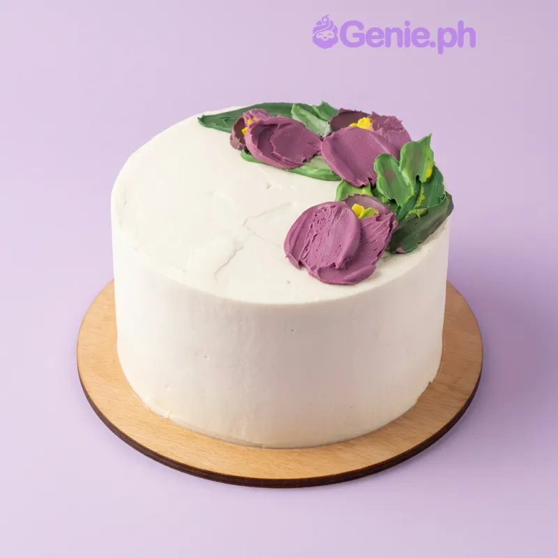 Floral Cake cake design — 1 layer soft icing cake in white — with piped purple flowers with green leaves, and piped purple flowers with green leaves Floral Cake cake design — 1 layer soft icing cake in white — with piped purple flowers with green leaves, and piped purple flowers with green leaves