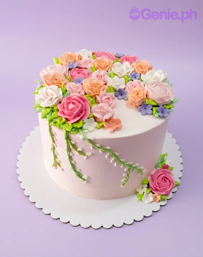 A pink 1 Tier cake themed Floral Garden, featuring multi-colored icing roses with green leaves and vines. A pink 1 Tier cake themed Floral Garden, featuring multi-colored icing roses with green leaves and vines.