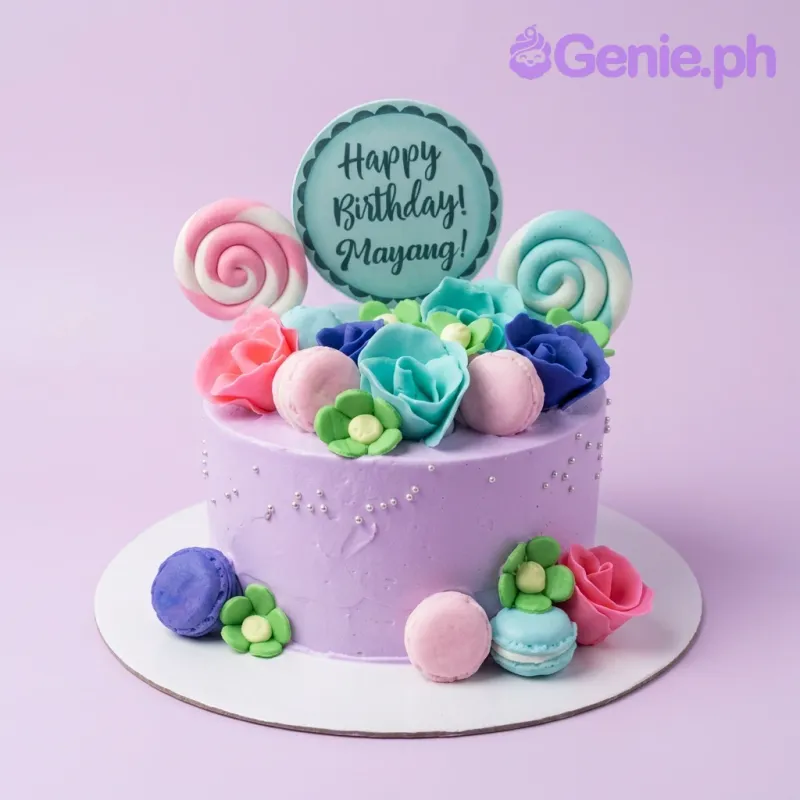 A purple 1-Tier Floral Macaron cake, featuring a 'Happy Birthday! Mayang!' topper, fondant roses, macarons, and lollipops. A purple 1-Tier Floral Macaron cake, featuring a 'Happy Birthday! Mayang!' topper, fondant roses, macarons, and lollipops.
