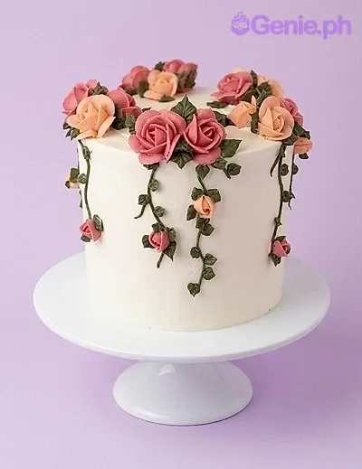 A white, pink, peach, and green 1 Tier cake themed around Floral Rose, featuring pink and peach icing roses and green vines. A white, pink, peach, and green 1 Tier cake themed around Floral Rose, featuring pink and peach icing roses and green vines.