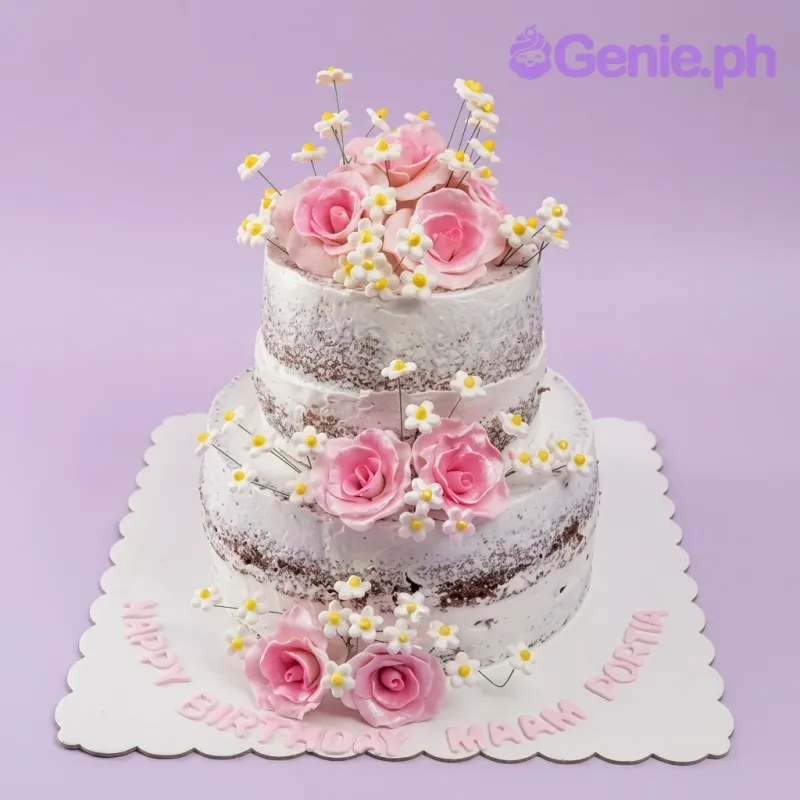 A white, chocolate, and pink two-tier semi-naked floral cake, with pink gumpaste roses, white daisies, and 'HAPPY BIRTHDAY MAAM PORTIA' text. A white, chocolate, and pink two-tier semi-naked floral cake, with pink gumpaste roses, white daisies, and 'HAPPY BIRTHDAY MAAM PORTIA' text.