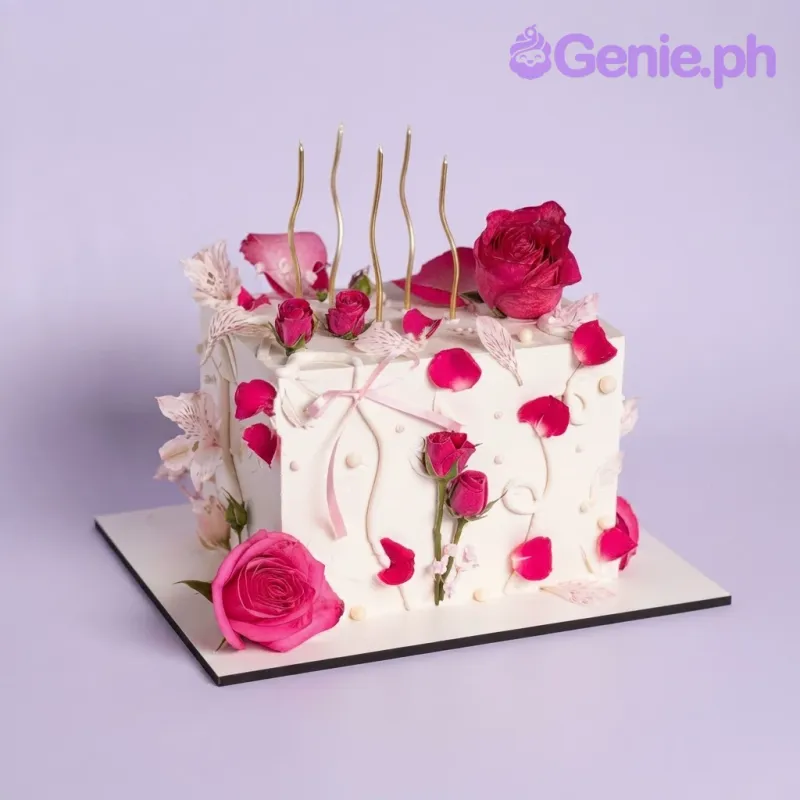 White square cake with smooth soft icing, dark red rose and candles, and dark red roses White square cake with smooth soft icing, dark red rose and candles, and dark red roses