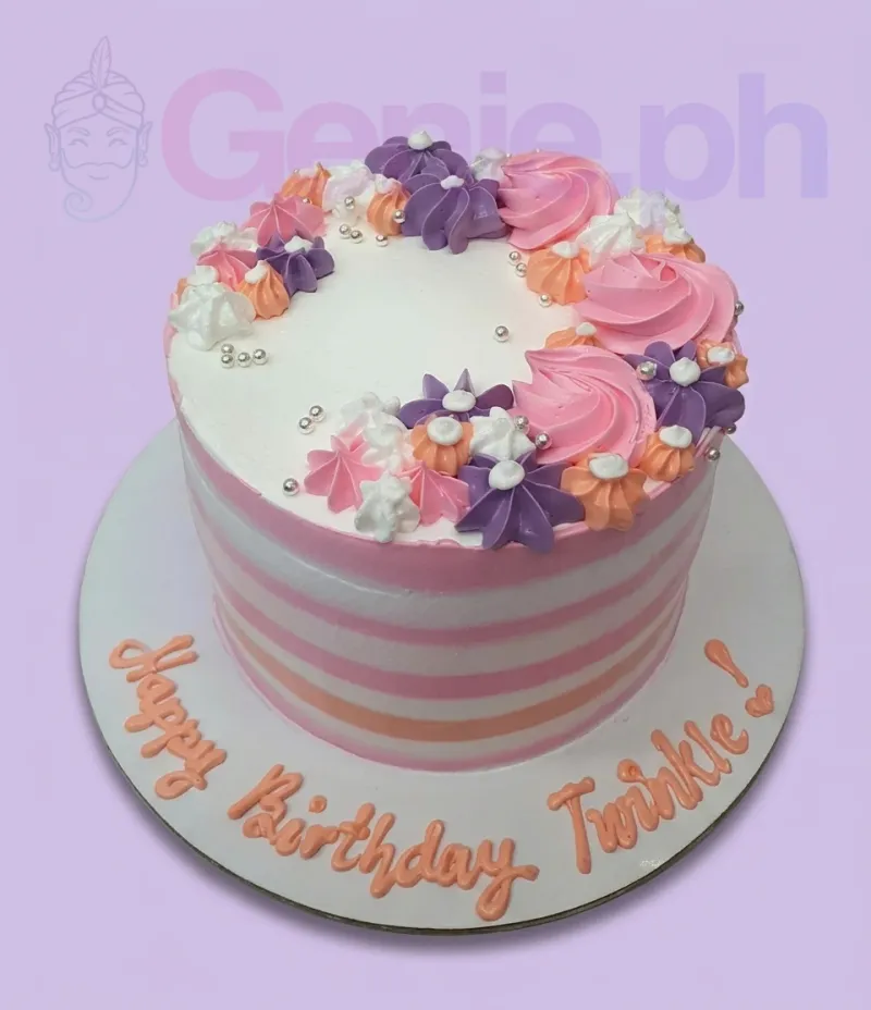 A white and pink striped 1 Tier cake featuring multicolor icing rosettes, silver dragees, and a birthday message. A white and pink striped 1 Tier cake featuring multicolor icing rosettes, silver dragees, and a birthday message.