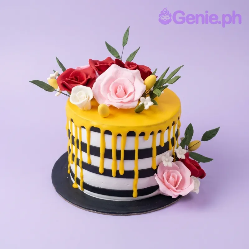A black and white striped 1-tier cake themed Floral Striped, featuring pink and red gumpaste roses, yellow drip, and green leaves. A black and white striped 1-tier cake themed Floral Striped, featuring pink and red gumpaste roses, yellow drip, and green leaves.