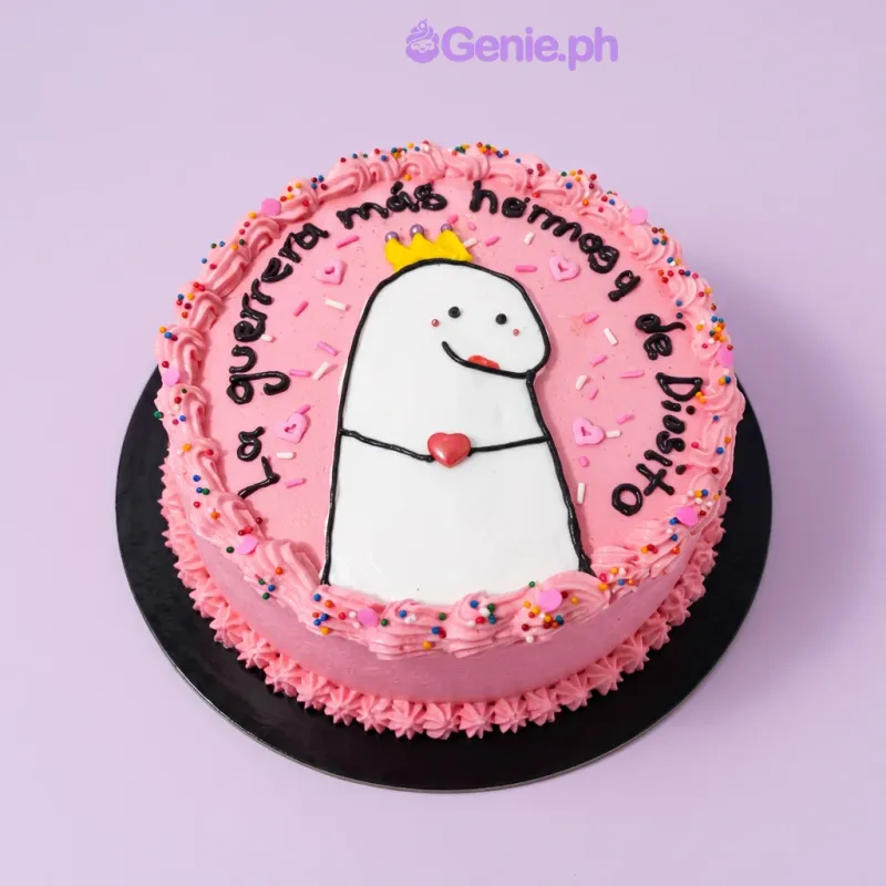 Pink round cake with a Flork character printout, a small fondant crown, and a heart, with piped icing borders and colorful sprinkles Pink round cake with a Flork character printout, a small fondant crown, and a heart, with piped icing borders and colorful sprinkles
