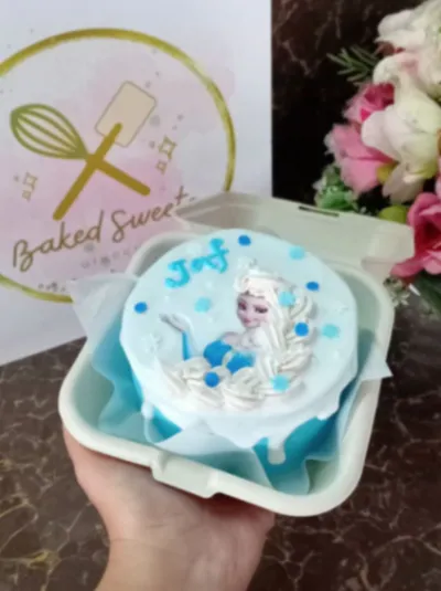Sky blue bento cake with soft icing, a white drip, an Elsa edible photo topper, and piped blue snowflakes Sky blue bento cake with soft icing, a white drip, an Elsa edible photo topper, and piped blue snowflakes