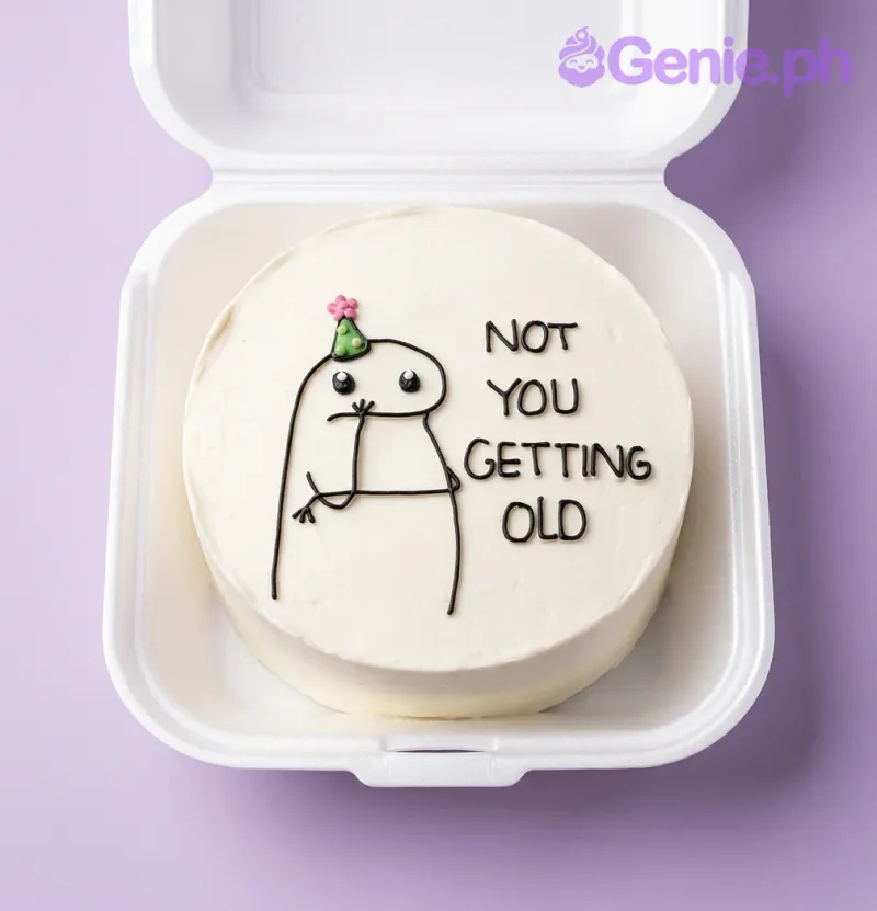 A white bento cake, funny birthday themed, with a hand-drawn crying stick figure wearing a party hat and 'NOT YOU GETTING OLD' text. A white bento cake, funny birthday themed, with a hand-drawn crying stick figure wearing a party hat and 'NOT YOU GETTING OLD' text.