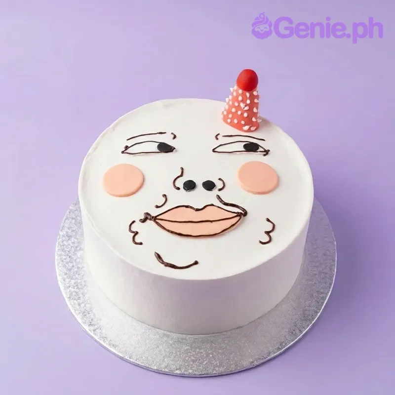 A white bento cake themed around Funny Face, featuring a small red and white polka dot party hat, a hand-drawn face, and pink blush cheeks. A white bento cake themed around Funny Face, featuring a small red and white polka dot party hat, a hand-drawn face, and pink blush cheeks.