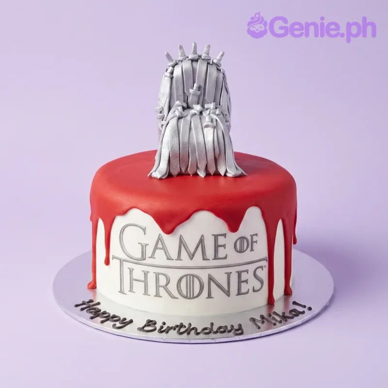 A white and red 1 Tier Fondant cake themed around Game Of Thrones, with a silver Iron Throne topper and Game of Thrones logo. A white and red 1 Tier Fondant cake themed around Game Of Thrones, with a silver Iron Throne topper and Game of Thrones logo.