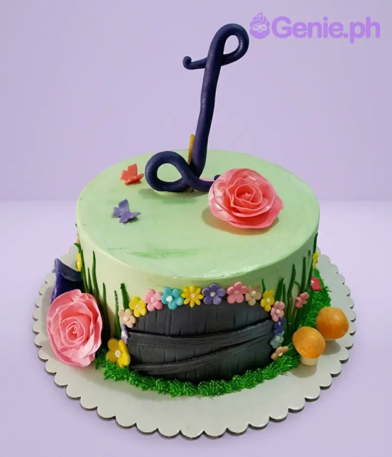 A light green 1-Tier garden-themed cake with a large purple letter J, pink roses, a wooden door, and multi-colored flowers. A light green 1-Tier garden-themed cake with a large purple letter J, pink roses, a wooden door, and multi-colored flowers.