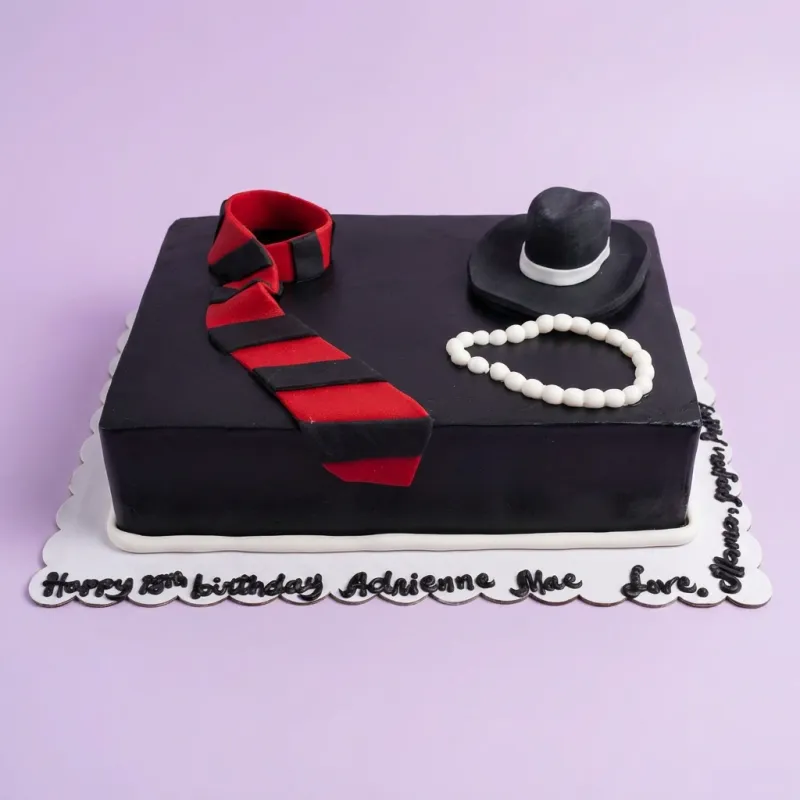 Black rectangle fondant cake with a red and black striped tie, a black fedora hat, and a white pearl necklace topper. Black rectangle fondant cake with a red and black striped tie, a black fedora hat, and a white pearl necklace topper.