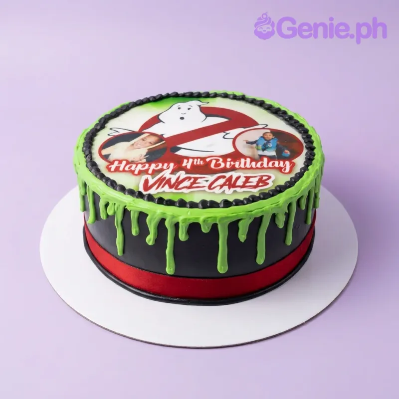 A black and green 1-tier cake themed around Ghostbusters, featuring an edible photo topper, green slime drip, and black icing rosettes. A black and green 1-tier cake themed around Ghostbusters, featuring an edible photo topper, green slime drip, and black icing rosettes.
