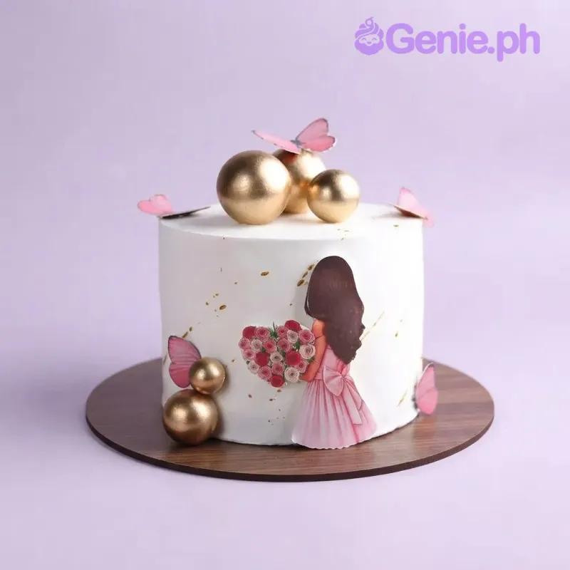 White 1-tier cake with a girl printout, gold spheres, and pink butterfly cutouts White 1-tier cake with a girl printout, gold spheres, and pink butterfly cutouts