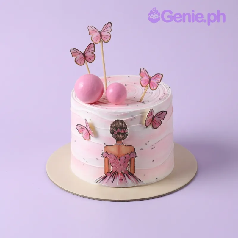 Pink and white gradient 1-tier cake with a girl printout and butterfly toppers Pink and white gradient 1-tier cake with a girl printout and butterfly toppers