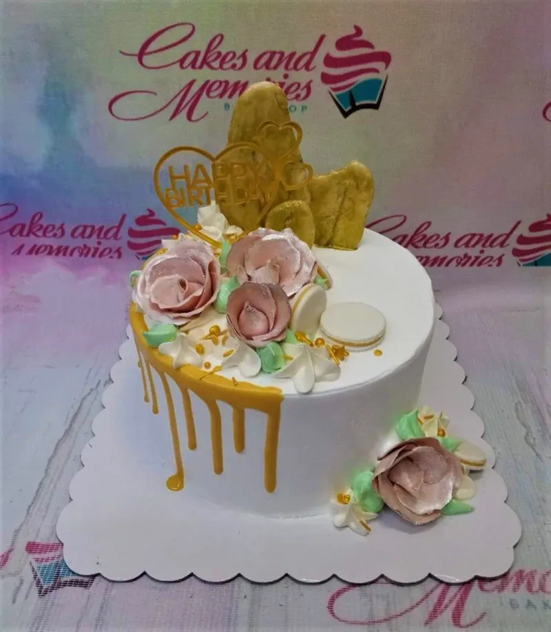 A white 1-tier round cake themed around Gold Drip Roses, featuring a gold Happy Birthday heart topper and pink edible roses. A white 1-tier round cake themed around Gold Drip Roses, featuring a gold Happy Birthday heart topper and pink edible roses.