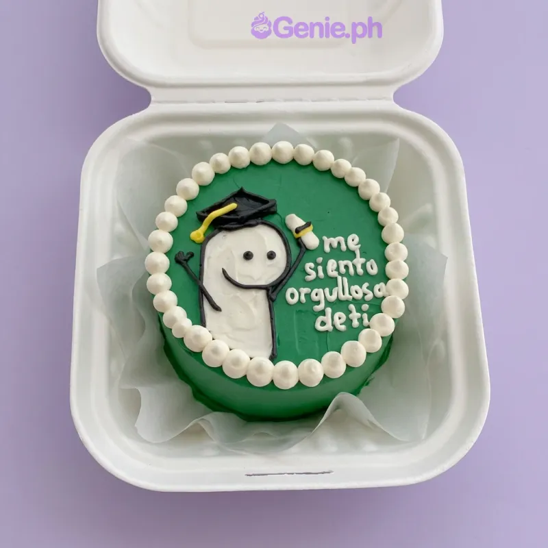 Green bento cake with Flork graduation character topper and white piped border Green bento cake with Flork graduation character topper and white piped border