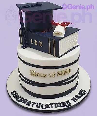 A navy blue, white, and gold 2 Tier Fondant Graduation cake, featuring a cap, a book, and 'Class of 2020' text. A navy blue, white, and gold 2 Tier Fondant Graduation cake, featuring a cap, a book, and 'Class of 2020' text.