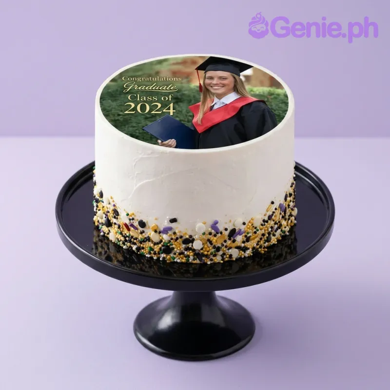 A white 1 Tier cake themed around Graduation, featuring an edible photo of a graduate and multicolor sprinkles. A white 1 Tier cake themed around Graduation, featuring an edible photo of a graduate and multicolor sprinkles.