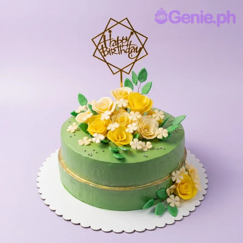 A green one-tier cake themed Green Floral, featuring a gold geometric Happy Birthday topper and gumpaste floral accents. A green one-tier cake themed Green Floral, featuring a gold geometric Happy Birthday topper and gumpaste floral accents.