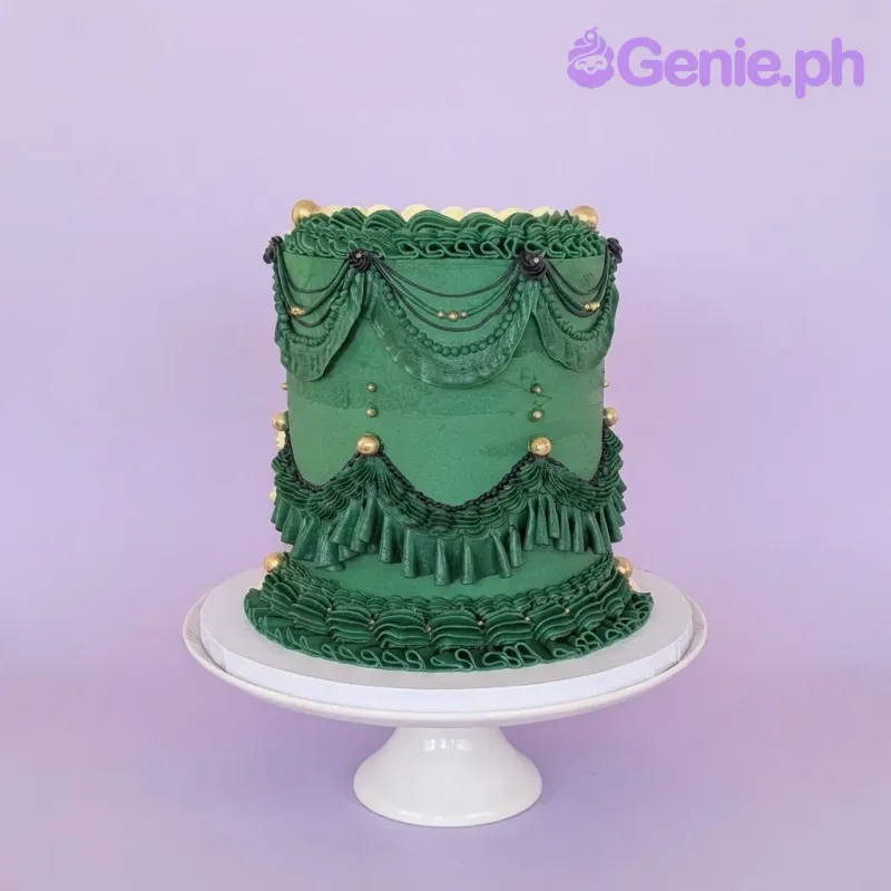 Ivory and green 1-tier vintage cake with smooth soft icing, intricate green Lambeth ruffles, and gold pearl accents Ivory and green 1-tier vintage cake with smooth soft icing, intricate green Lambeth ruffles, and gold pearl accents