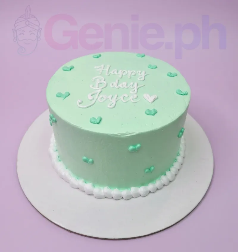 Light green minimalist bento cake with white piped birthday message and small green icing hearts. Light green minimalist bento cake with white piped birthday message and small green icing hearts.
