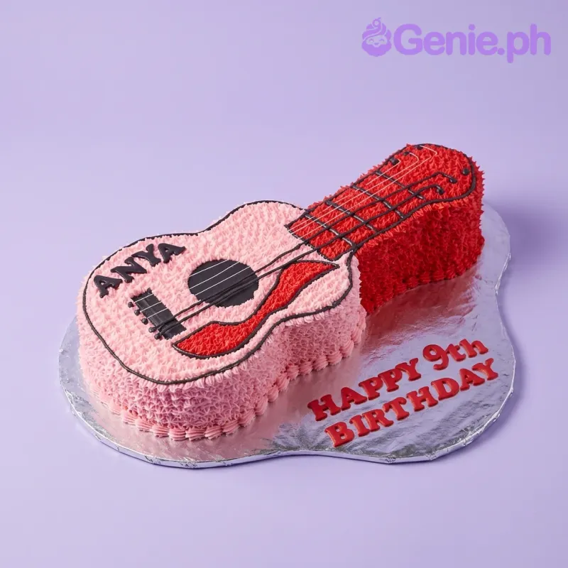 A pink, red, and black guitar-shaped cake themed around music, featuring icing rosettes, "ANYA" text, and black string details. A pink, red, and black guitar-shaped cake themed around music, featuring icing rosettes, "ANYA" text, and black string details.