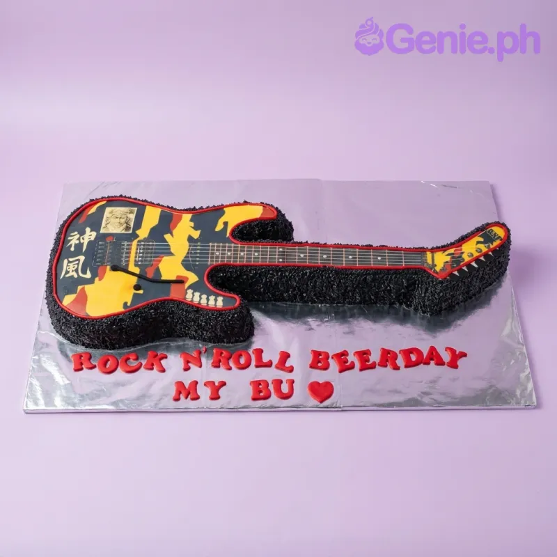 A black and silver guitar-shaped cake themed around Guitar Rock N Roll, featuring guitar printouts, red gumpaste text, and a red heart. A black and silver guitar-shaped cake themed around Guitar Rock N Roll, featuring guitar printouts, red gumpaste text, and a red heart.