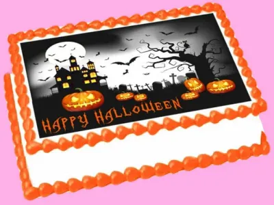 A white Rectangle Halloween cake with orange borders, featuring a haunted house, pumpkin, and bat print. A white Rectangle Halloween cake with orange borders, featuring a haunted house, pumpkin, and bat print.