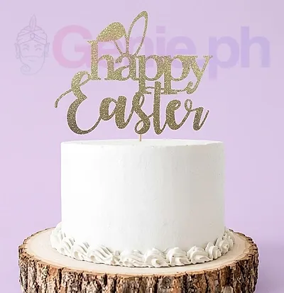A white and gold 1-tier Easter cake, featuring a gold 'Happy Easter' topper and white icing rosettes. A white and gold 1-tier Easter cake, featuring a gold 'Happy Easter' topper and white icing rosettes.