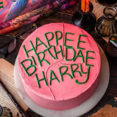 Hot pink 1-tier birthday cake with smooth soft icing, Harry Potter theme, and a piped message Hot pink 1-tier birthday cake with smooth soft icing, Harry Potter theme, and a piped message