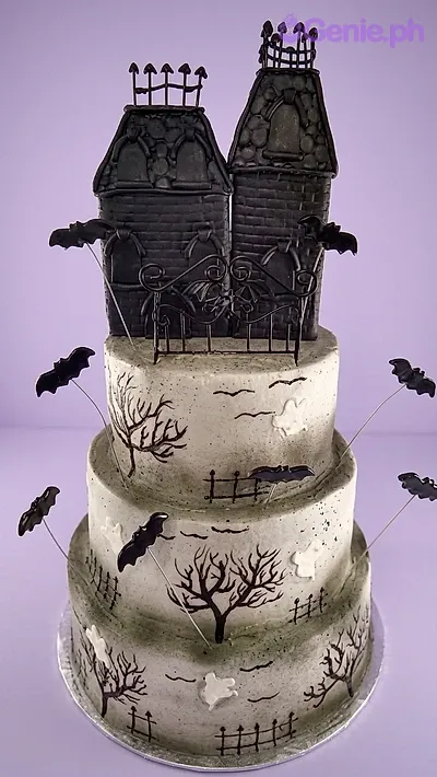A grey-washed, black 3 Tier Fondant Haunted House Halloween cake with fondant houses, bats, and tree silhouettes. A grey-washed, black 3 Tier Fondant Haunted House Halloween cake with fondant houses, bats, and tree silhouettes.
