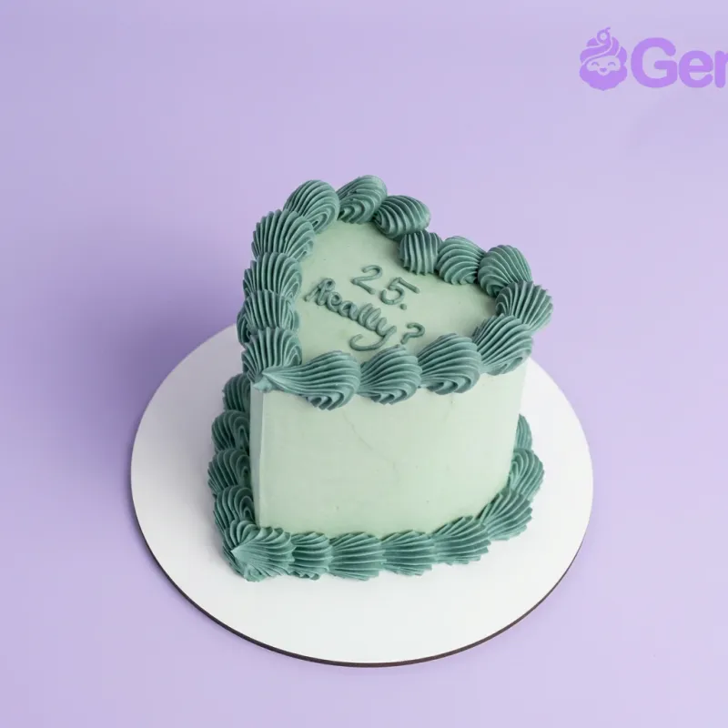 Light green heart-shaped cake with teal piped borders and 25 Really text on top Light green heart-shaped cake with teal piped borders and 25 Really text on top