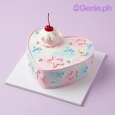 Heart-shaped cake with pink and blue gradient icing, topped with a red cherry, piped bows, and fondant stars Heart-shaped cake with pink and blue gradient icing, topped with a red cherry, piped bows, and fondant stars