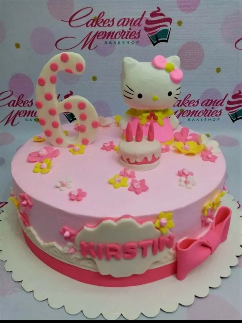 A pink 1-tier cake themed around Hello Kitty, featuring a large number 6 topper and edible fondant flowers. A pink 1-tier cake themed around Hello Kitty, featuring a large number 6 topper and edible fondant flowers.