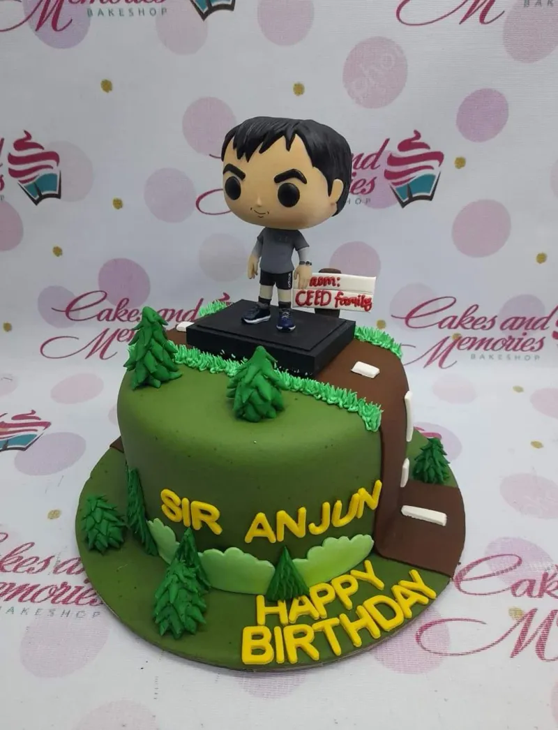 A green and brown 1 Tier Fondant cake themed around Hiking, featuring a 3D male figure, fondant pine trees, and yellow gumpaste messages. A green and brown 1 Tier Fondant cake themed around Hiking, featuring a 3D male figure, fondant pine trees, and yellow gumpaste messages.