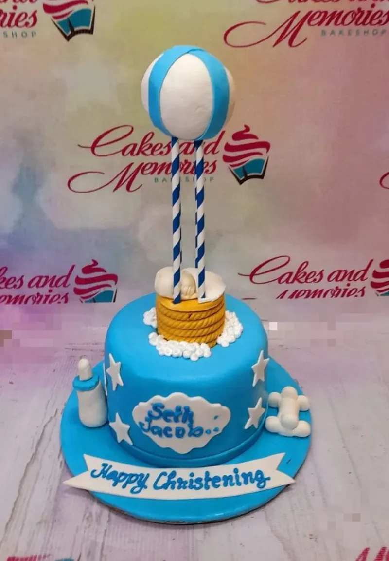 Blue and white 1-tier fondant Hot Air Balloon Christening cake, with a sleeping baby, clouds, and stars. Blue and white 1-tier fondant Hot Air Balloon Christening cake, with a sleeping baby, clouds, and stars.