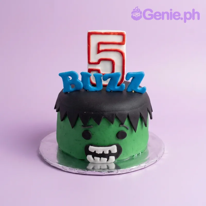 Green Hulk-themed fondant cake with a large number 5 topper and blue gumpaste letters spelling BUZZ. Green Hulk-themed fondant cake with a large number 5 topper and blue gumpaste letters spelling BUZZ.