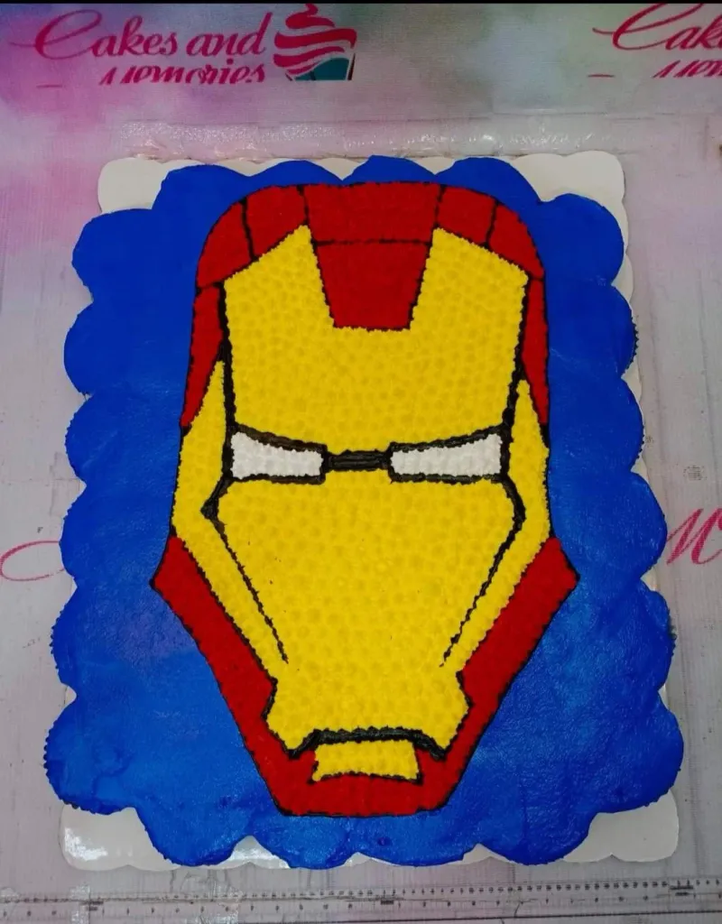 Iron Man face pull-apart cupcake cake with red, yellow, and blue icing details. Iron Man face pull-apart cupcake cake with red, yellow, and blue icing details.