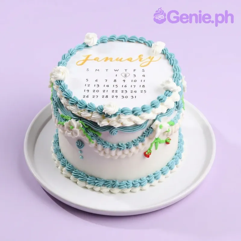 A white and light blue 1 Tier cake themed around a January Calendar, featuring a January calendar printout with a heart, light blue and white icing ruffles, and "January 2" text. A white and light blue 1 Tier cake themed around a January Calendar, featuring a January calendar printout with a heart, light blue and white icing ruffles, and "January 2" text.