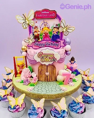 A pink and green 1-tier cake themed Jollibee Fairytale Land, with characters, a number 7 candle, and butterflies. A pink and green 1-tier cake themed Jollibee Fairytale Land, with characters, a number 7 candle, and butterflies.