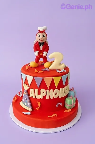 A red 1 Tier Fondant cake themed around Jollibee, featuring a 3D Jollibee figure, fondant number 2, and colorful bunting flags with confetti. A red 1 Tier Fondant cake themed around Jollibee, featuring a 3D Jollibee figure, fondant number 2, and colorful bunting flags with confetti.