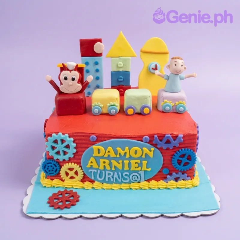 A red rectangular Jollibee themed cake, featuring edible Jollibee and boy figures, colorful gears, and a blue name plaque. A red rectangular Jollibee themed cake, featuring edible Jollibee and boy figures, colorful gears, and a blue name plaque.