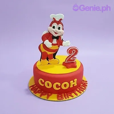 A red and yellow 1 Tier Fondant cake themed around Jollibee, featuring a 3D Jollibee figure and a red number 2 candle. A red and yellow 1 Tier Fondant cake themed around Jollibee, featuring a 3D Jollibee figure and a red number 2 candle.