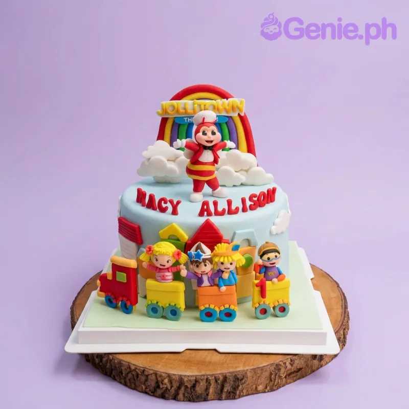 A light blue 1 Tier Fondant cake themed around Jollitown, featuring Jollitown characters, rainbow, and train. A light blue 1 Tier Fondant cake themed around Jollitown, featuring Jollitown characters, rainbow, and train.