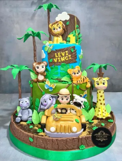 Sky blue and green 2-tier cake with soft icing, Jungle Safari Cake theme, lion topper, and palm trees Sky blue and green 2-tier cake with soft icing, Jungle Safari Cake theme, lion topper, and palm trees