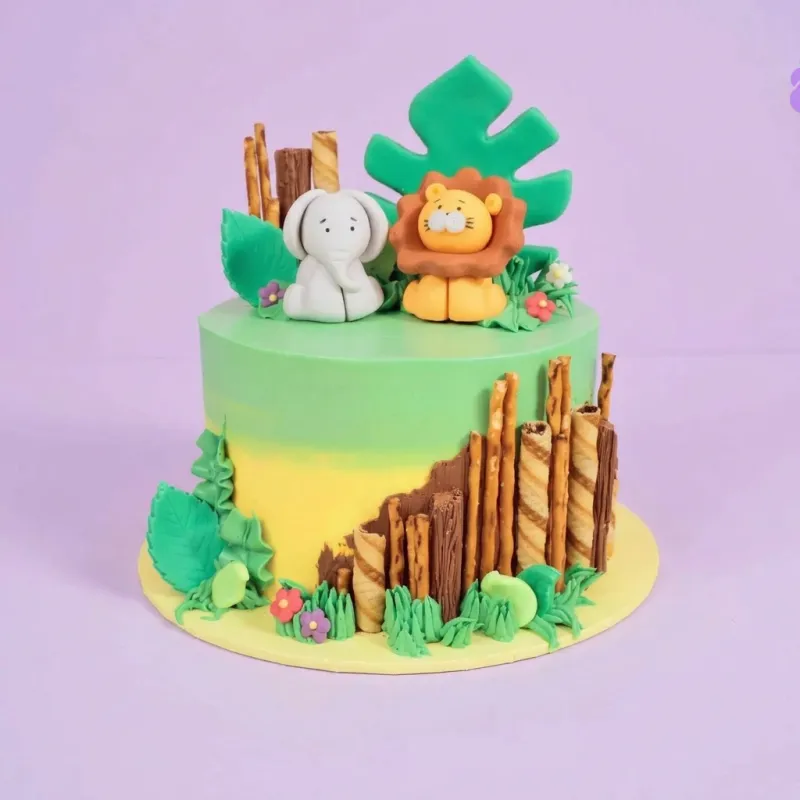 Jungle Safari fondant cake with gradient mint green, elephant, lion, and green leaf toppers Jungle Safari fondant cake with gradient mint green, elephant, lion, and green leaf toppers