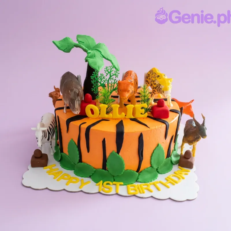 An orange 1 Tier Jungle Safari cake with black tiger stripes, plastic animal toys, and green fondant leaves. An orange 1 Tier Jungle Safari cake with black tiger stripes, plastic animal toys, and green fondant leaves.