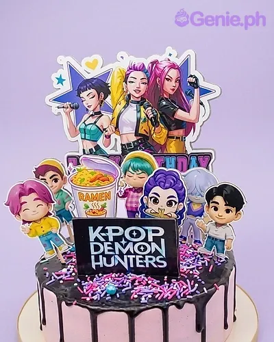 A pink and black 1-tier K-Pop Demon Hunters cake, with character printouts, a ramen cup, black drip, and sprinkles. A pink and black 1-tier K-Pop Demon Hunters cake, with character printouts, a ramen cup, black drip, and sprinkles.