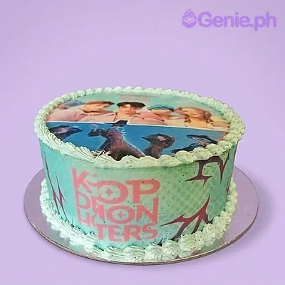 A mint green 1-tier Kpop Demon Hunters cake, with an edible group photo print, pink text, and mint green icing borders. A mint green 1-tier Kpop Demon Hunters cake, with an edible group photo print, pink text, and mint green icing borders.